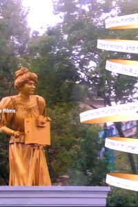 Screen Grab of Golden statue of Alice risign from Seine River with animated rings with text